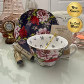 Navy red rose floral tea leaf reading cup set with gold crystal teaspoon, loose-leaf tea tube samplers and saucer, displayed with Fortune Telling Teacup card