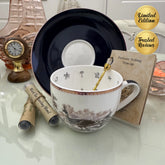 Peacock navy blue floral tea leaf reading cup set with gold crystal teaspoon, loose-leaf tea tube samplers and saucer, displayed with Fortune Telling Teacup card