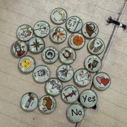 22 major arcana tarot buttons. These make a great gift for an occult lover and you can mix them up in your charm casting tools. They make a great addition to layering over your tarot card readings. Great gift idea.