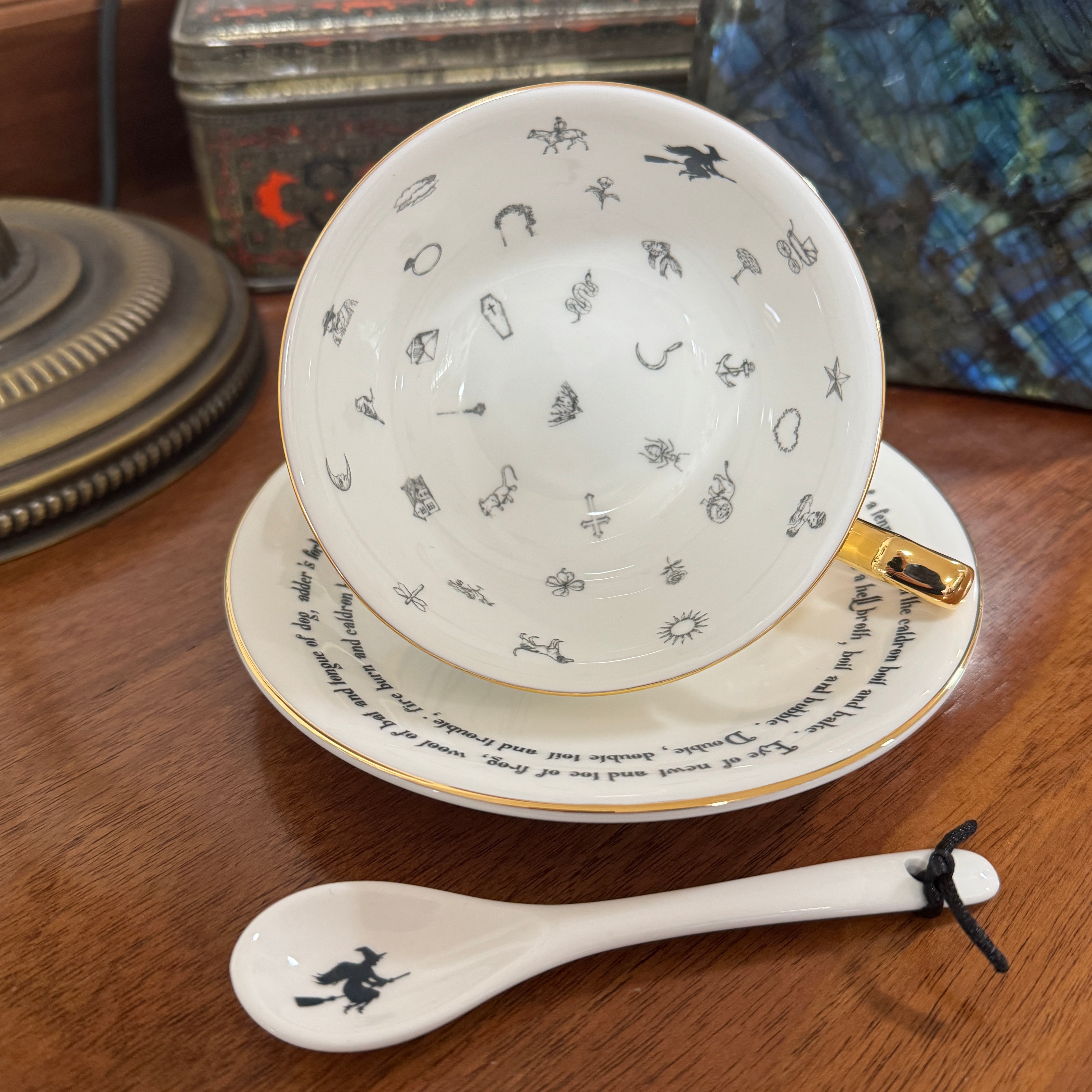 Witches Brew Tea Leaf Reading Teacup Set 227 – White teacup and saucer featuring gold witches brew symbols for fortune telling and tea leaf reading