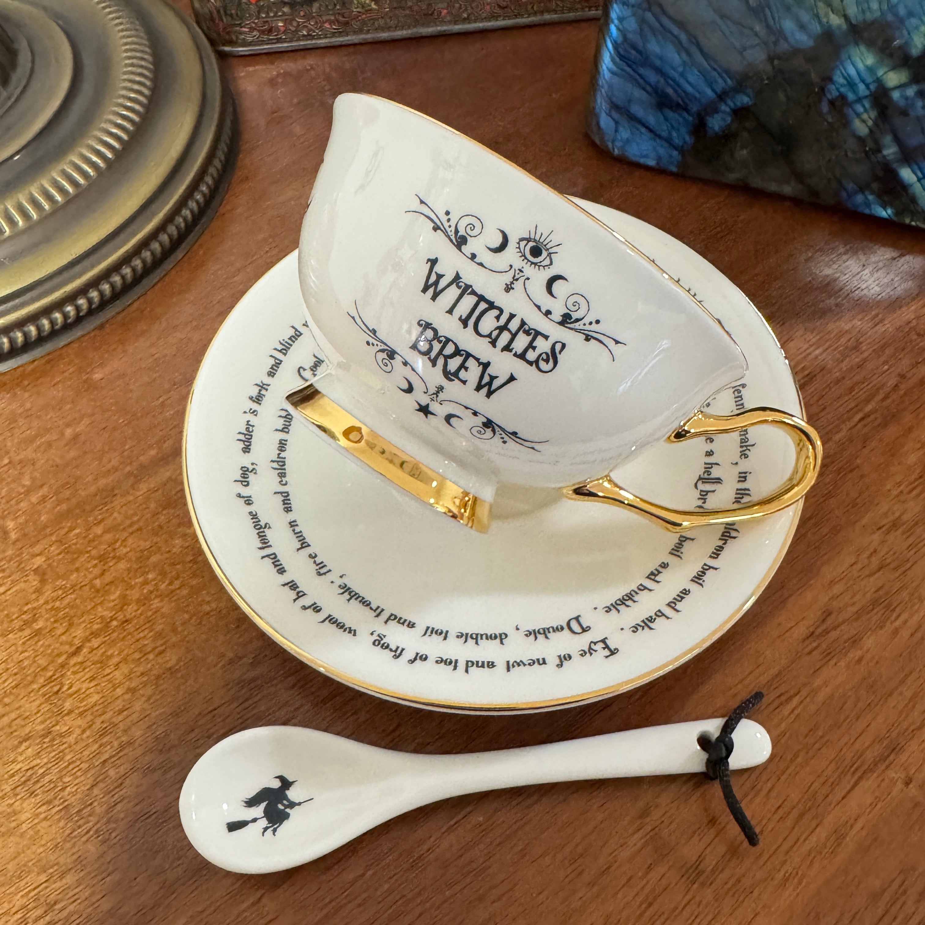 Witches Brew Tea Leaf Reading Teacup Set 227 – Styled product shot of white witches brew teacup and saucer with 24ct gold symbols