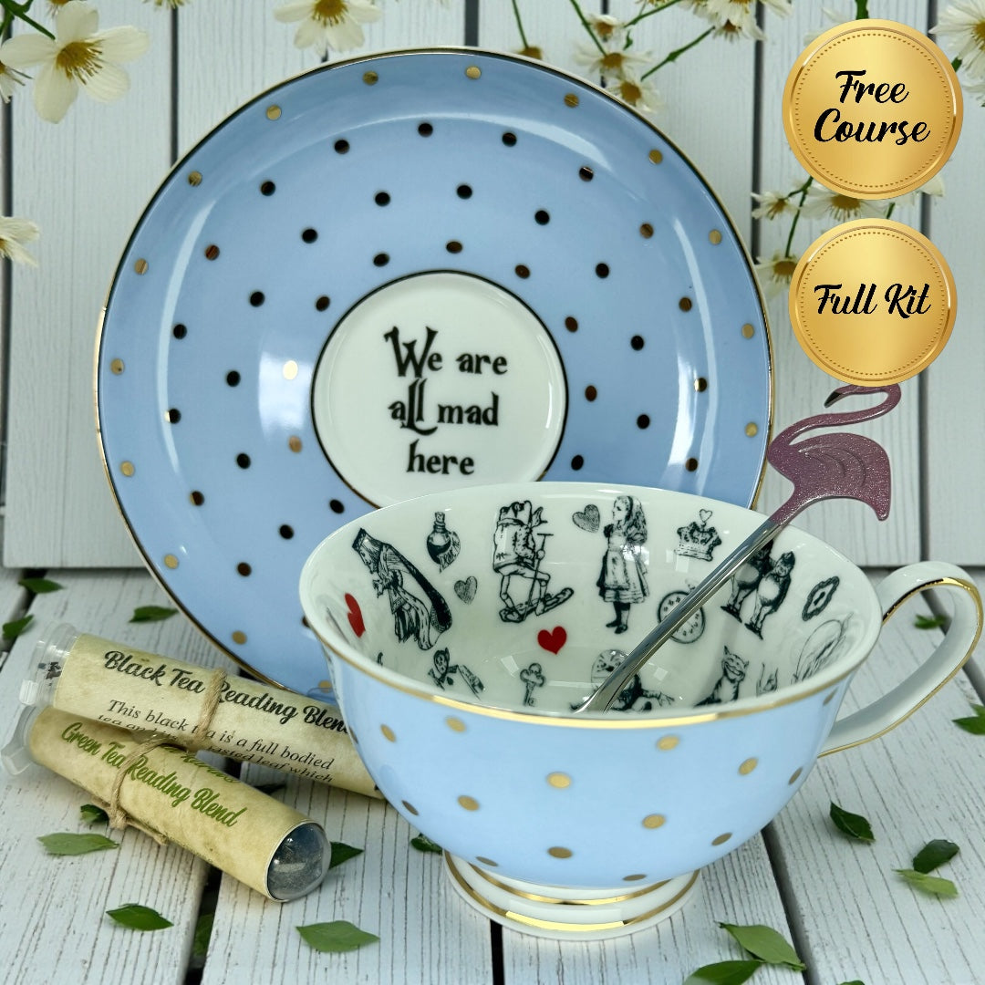 Blue polka dot teacup and saucer set with Alice in Wonderland graphics, pink flamingo spoon, and two rolled