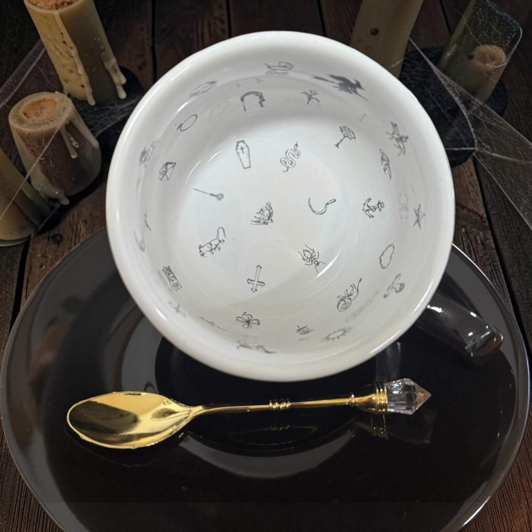Inside the Black Witchy teacup showing 32 tea leaf reading symbols and a witch on her broomstick