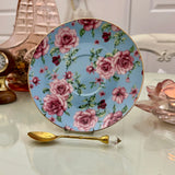 Blue pink rose floral ceramic saucer with gold rim from tea leaf reading cup set, displayed with gold crystal teaspoon