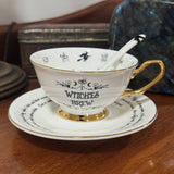 Witches Brew Tea Leaf Reading Teacup Set 227 – Side angle of white fortune telling teacup with permanently fired 24ct gold witches symbols