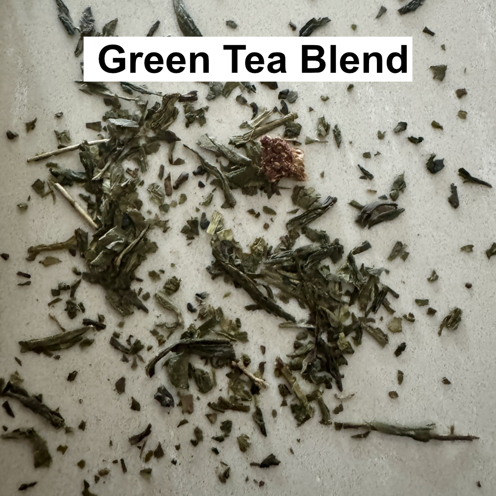 Karin's own Green tea leaf reading blend of tea scattered on a light surface
