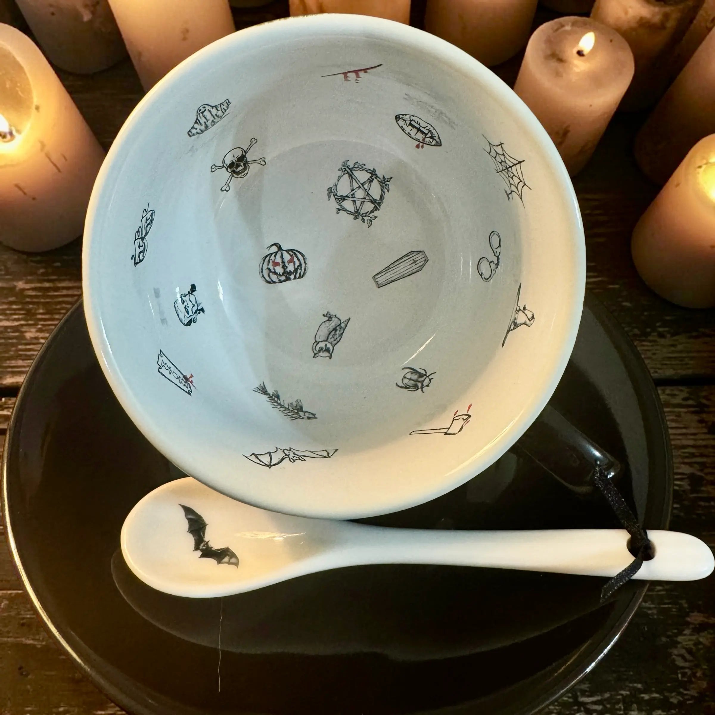 Inside the jet black Halloween teacup showing 18 Halloween tea leaf reading symbols