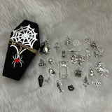 Set of 23 Halloween-themed charms in a black coffin box, each with spooky details, accompanied by a meanings sheet, ideal for charm casting, divination, and Halloween parties.