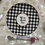 Alice in Wonderland teacup and saucer set with gold accents, accompanied by a matching teaspoon and tea samples, perfect for tea leaf reading and divination