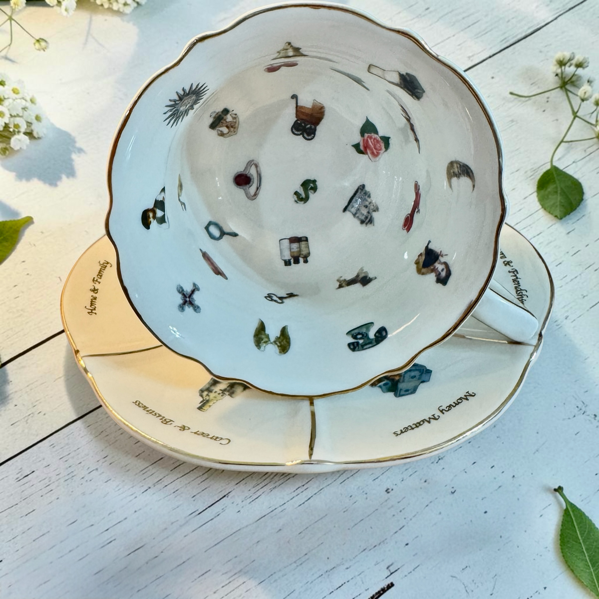 Labyrinth teacup showing 25 coloured symbols inside, on its saucer