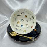 Teacup on its side showing the white interior printed with various emojis and profanity-laced fortune-telling words.
