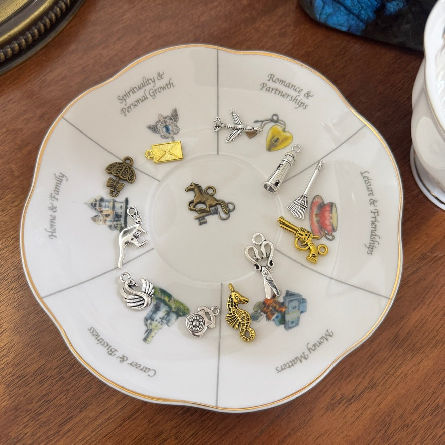 Decorative plate with various charms on a wooden surface