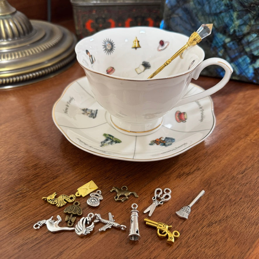 Teacup with decorative charms on a wooden surface