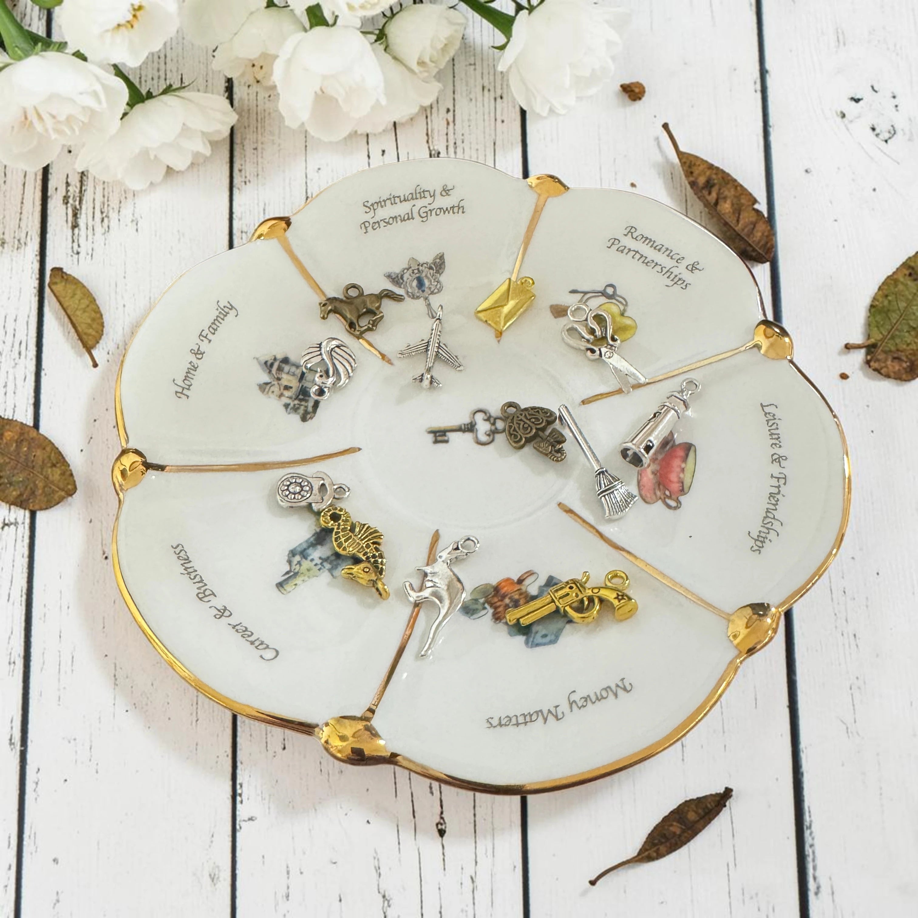 Labyrinth Through Time white teacup, saucer and tea leaf reading charms laid flat