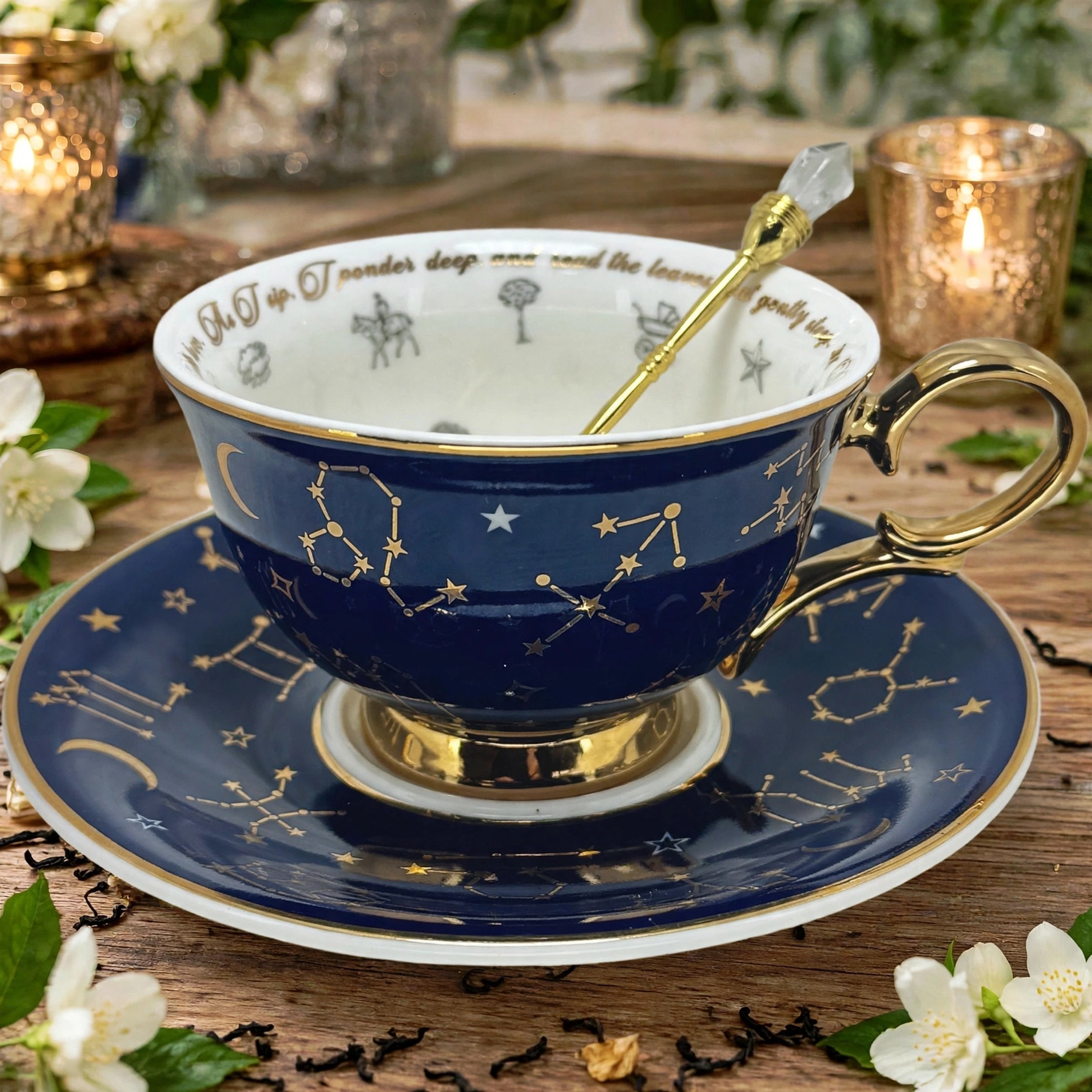 Navy blue astrologyNavy blue astrology, tea cup sitting on it saucer showing the real 24 karat gold zodiac symbols on both the teacup and the saucer. It has a little gold crystal spoon sitting inside the cup.