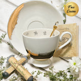 Luxury teacup with a heart-shaped design that appears when tea is poured, featuring permanent gold accents and intricate symbols inside, perfect for tea leaf reading and divination.