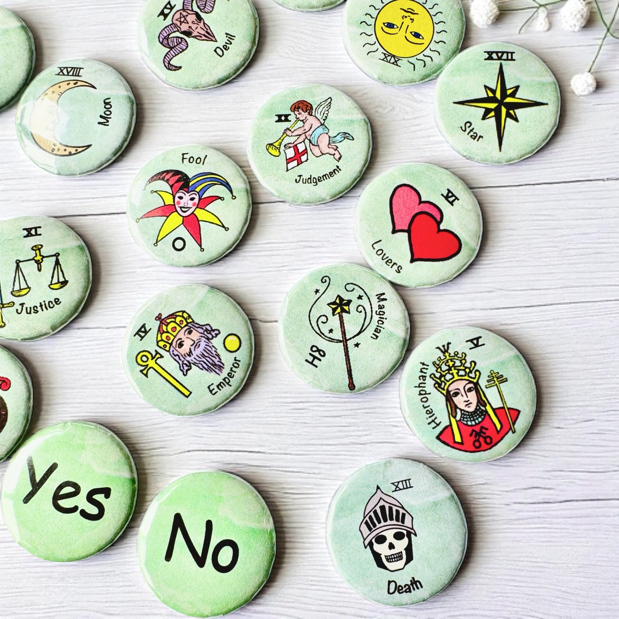 Set of 1-inch tarot buttons featuring the Major Arcana images on a pale mint green background, protected by a clear plastic coating, ideal for tarot, charm casting, and discreet divination in everyday settings