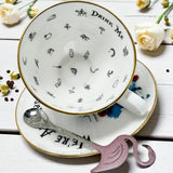 Side angle of the Alice in Wonderland punk teacup and matching saucer with detailed design