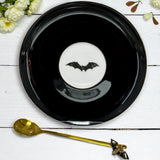 Black bat fortune telling teacup and saucer set with bat inside the teacup and also on the saucer. 