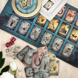 Magic & Mystery. This is a full divination system all in one travel kit tin.  It has washable spandex mat and 18 cards and 18 charms and 3 dice.