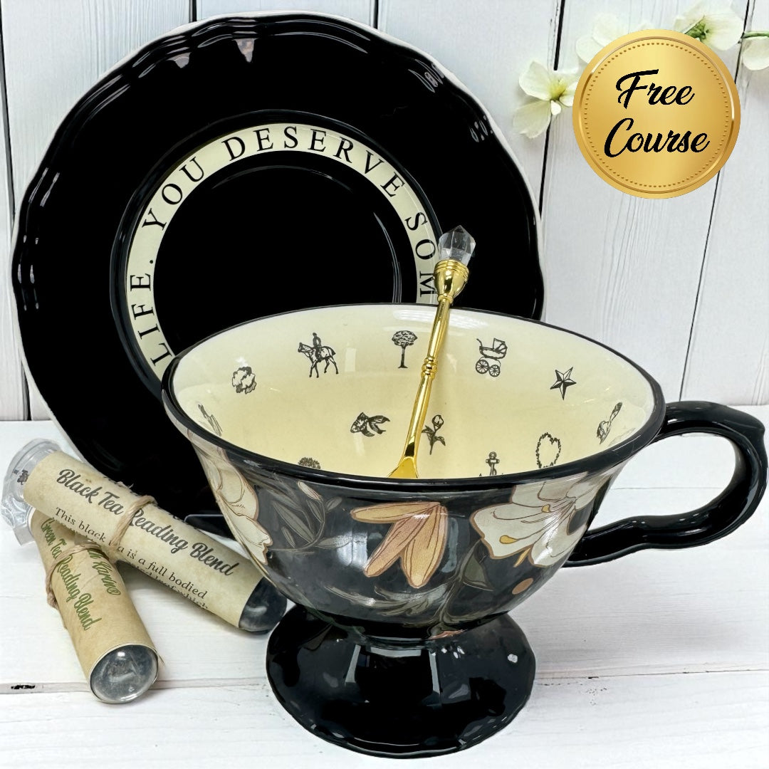 Black teacup with decorative interior, spoon, and tea packaging on a white surface.