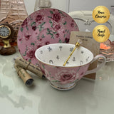 Pink rose floral tea leaf reading cup set with gold teaspoon, loose-leaf tea tube samplers and saucer, displayed with Fortune Telling Teacup card