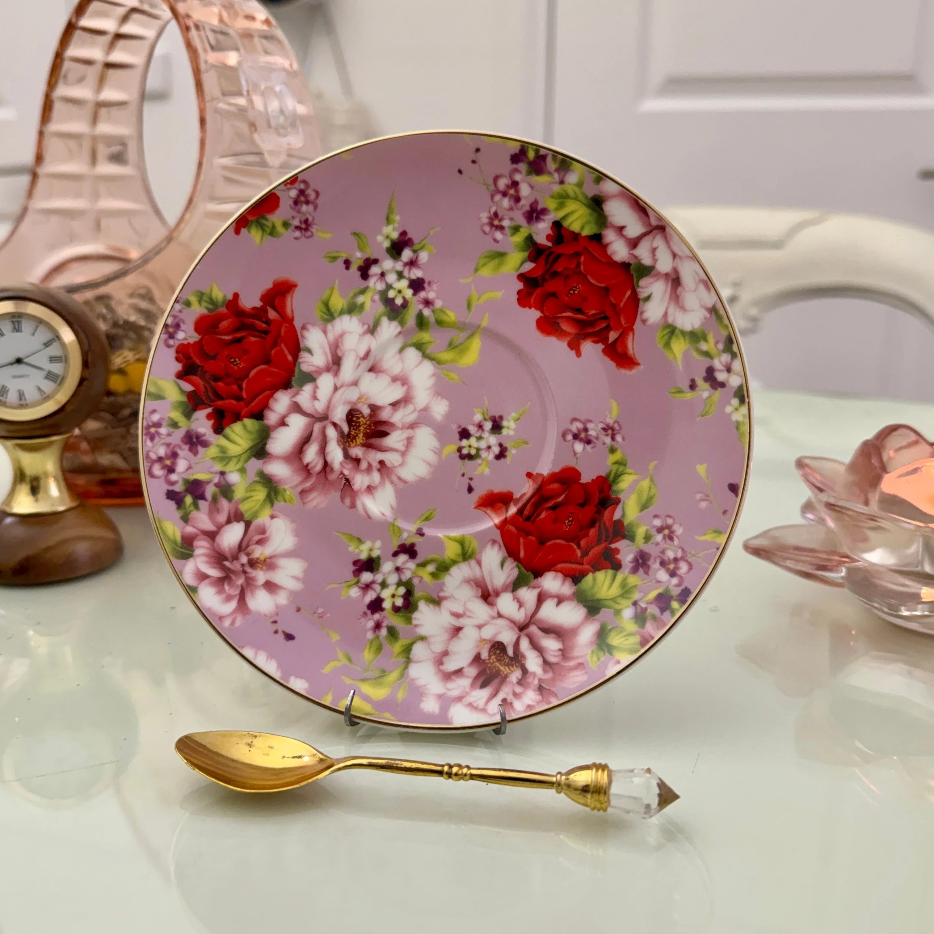 Pink red rose floral ceramic saucer with gold rim from tea leaf reading cup set, displayed with gold crystal teaspoon
