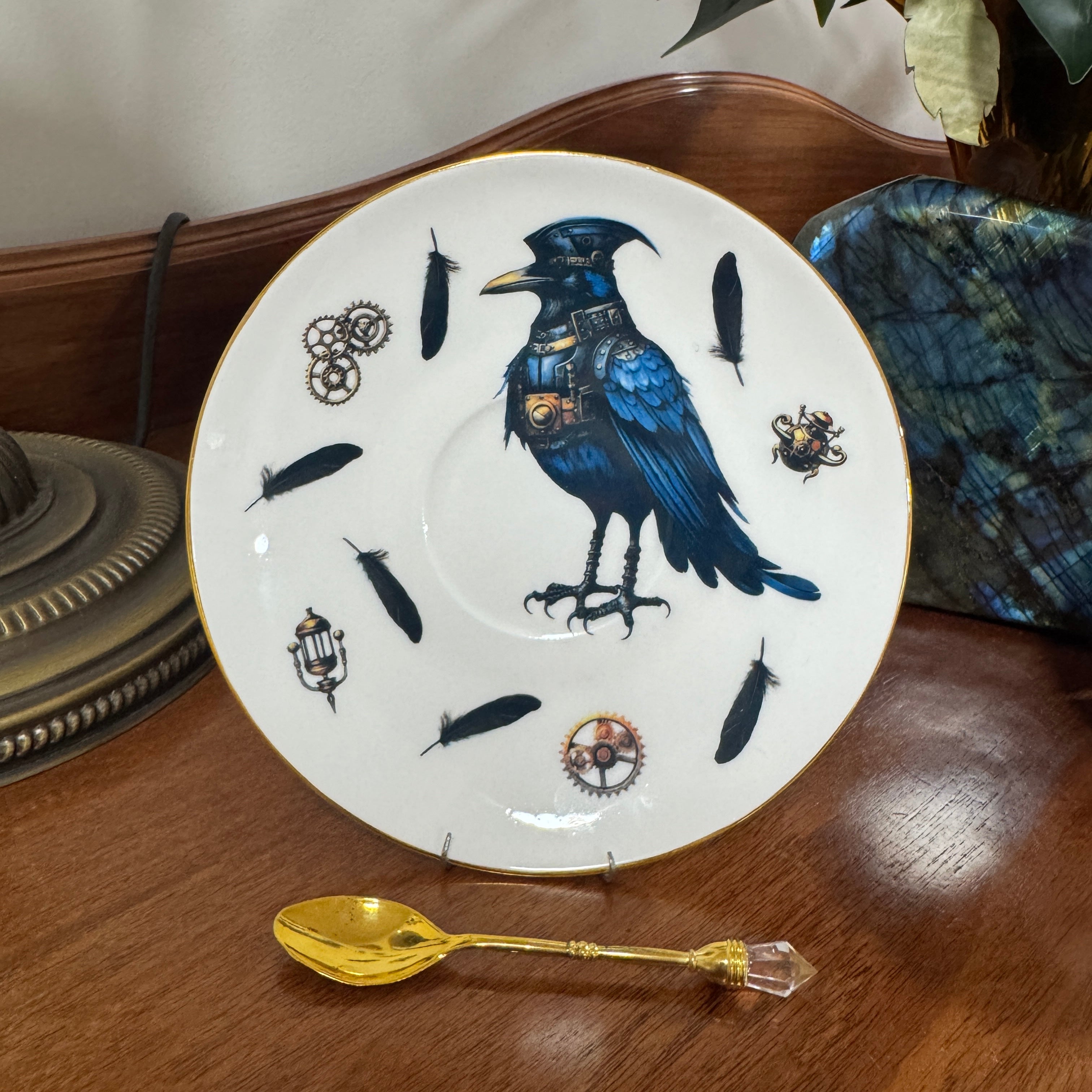 Decorative plate with a blue bird design on a wooden surface with a gold spoon.