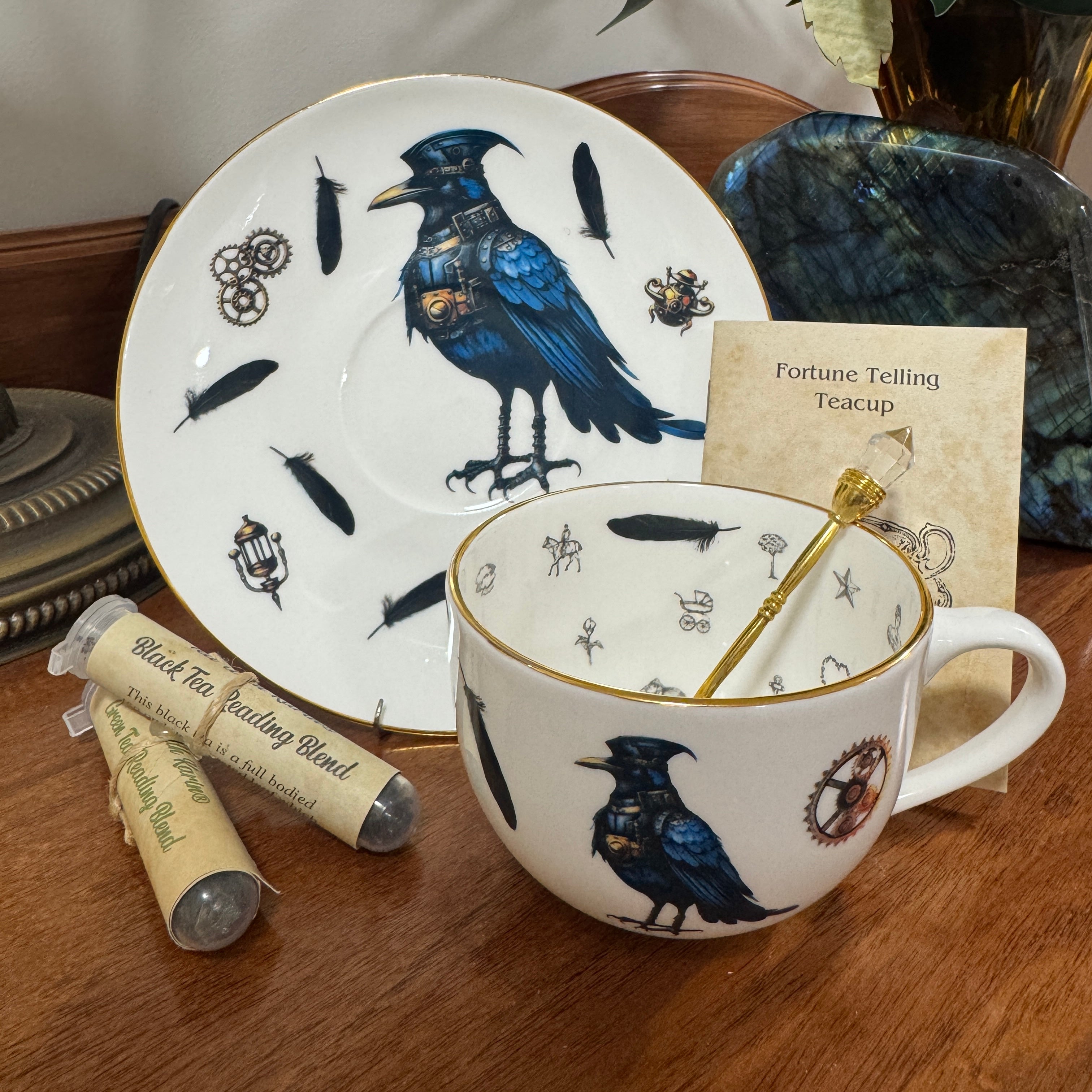 Tea cup and saucer set with raven design on a wooden surface
