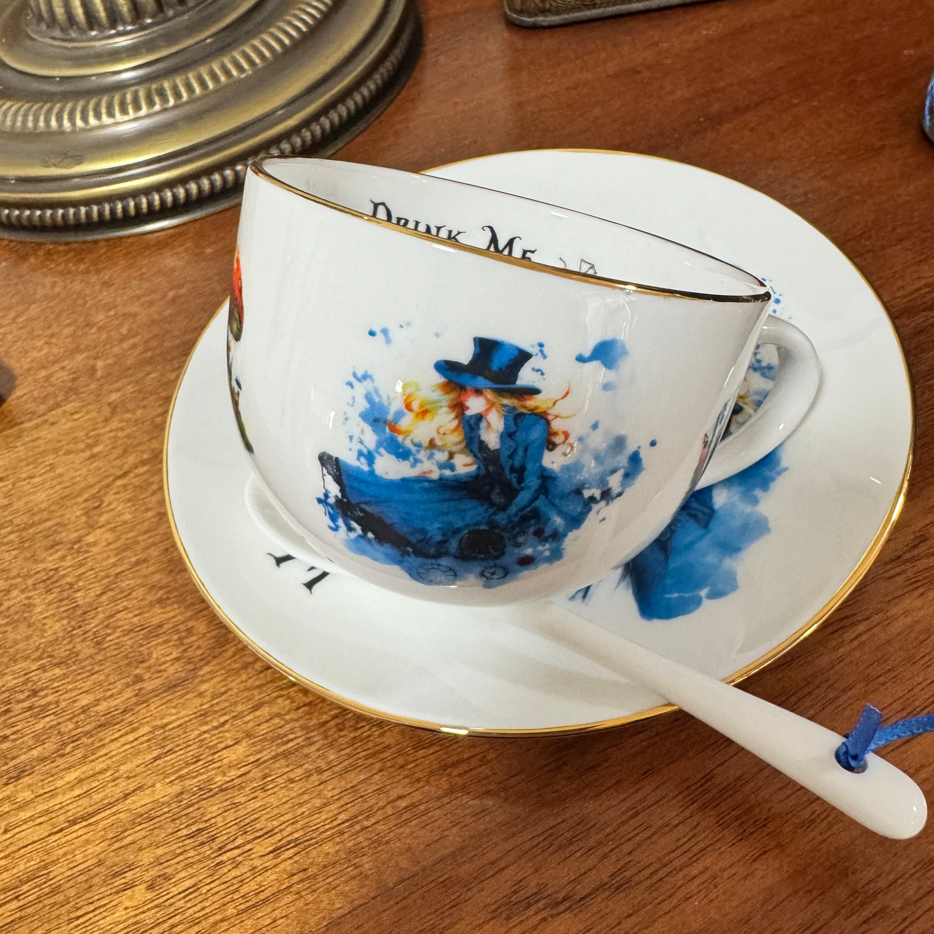 Decorative teacup and saucer with artistic design on a wooden surface