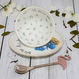 Inside the Alice fortune teller teacup: Drink Me lettering and 32 printed tea leaf reading symbols, with pink flamingo teaspoon