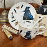 Tea cup with decorative design, spoon, and tea packaging on a wooden surface.