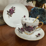 Tea cup and saucer with floral design on a wooden surface