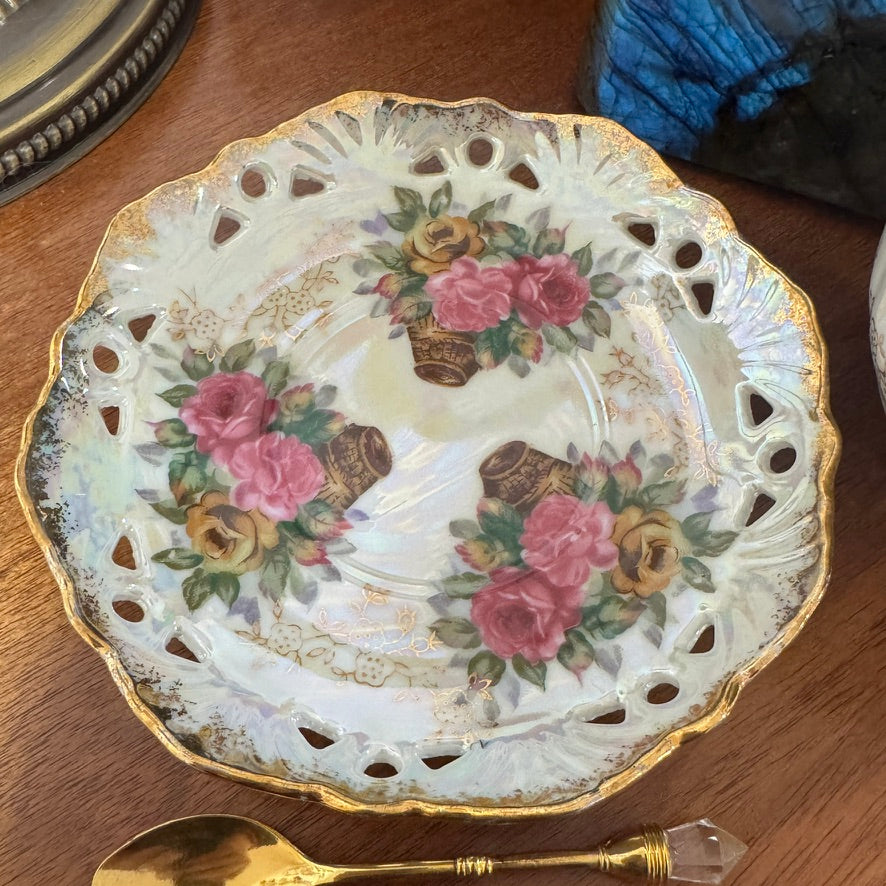 Decorative ceramic plate with floral design on a wooden surface