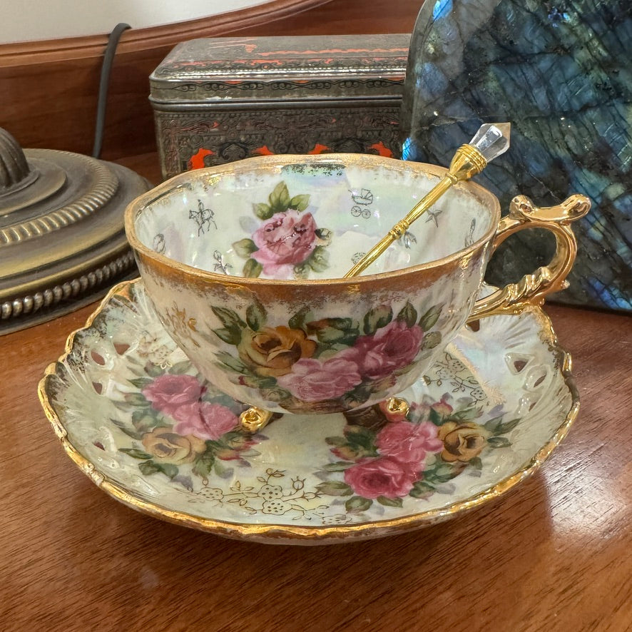 Decorative teacup with floral patterns on a wooden surface