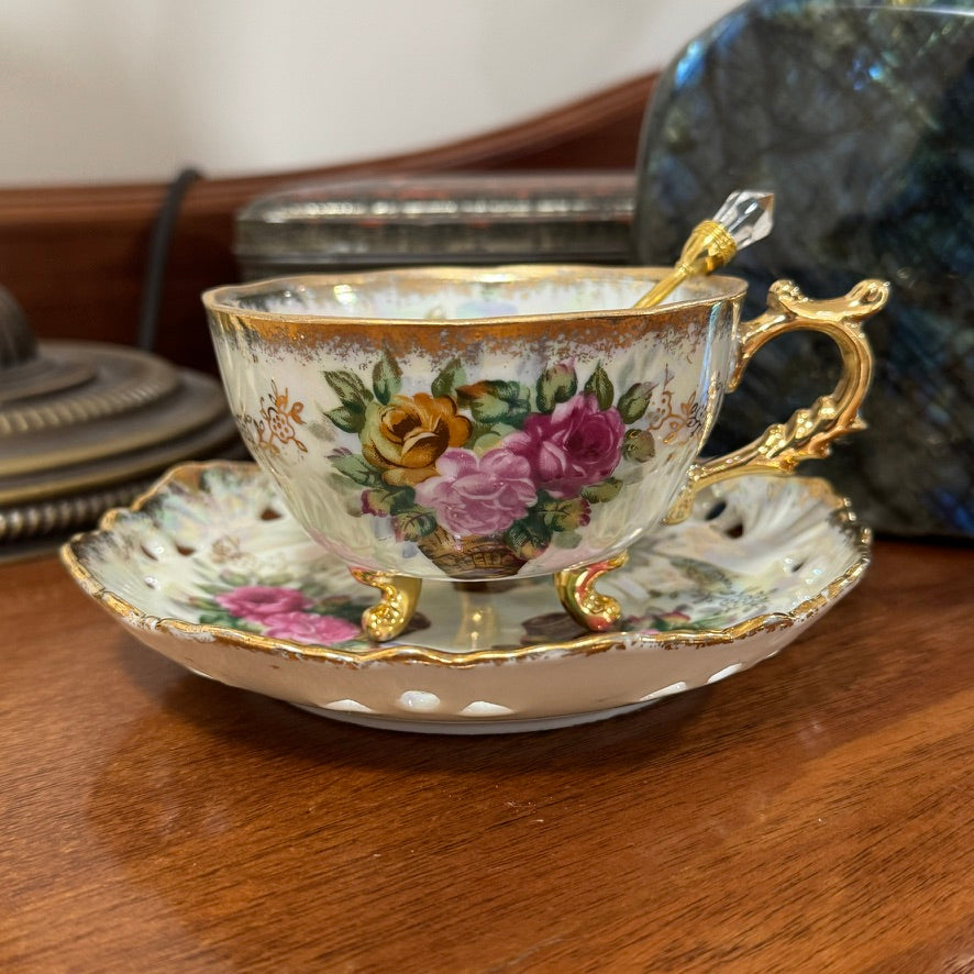 Decorative teacup with floral design on a wooden surface