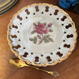 Decorative plate with rose design on a wooden surface