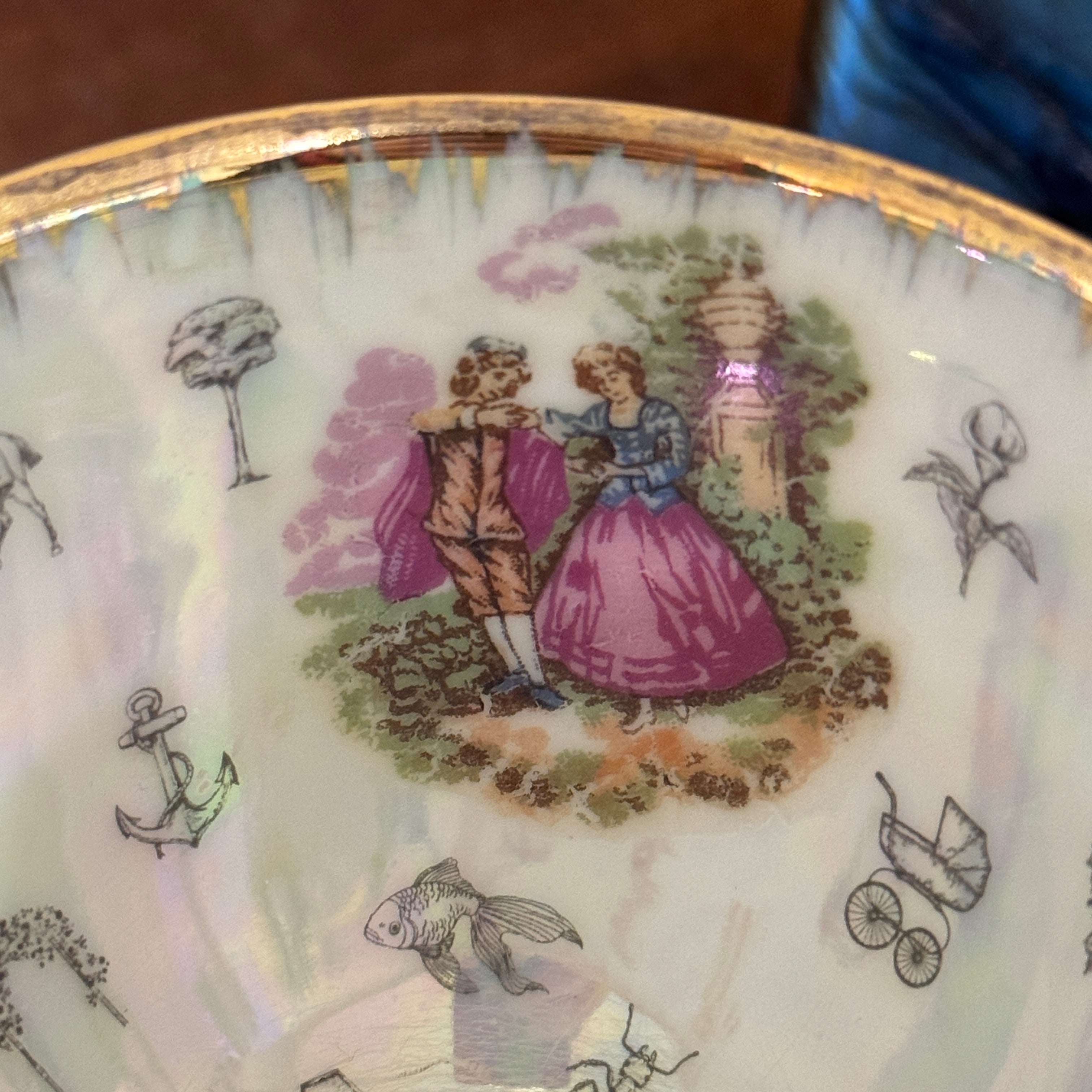 Decorative plate with a romantic scene of a couple and various symbols on a white background.
