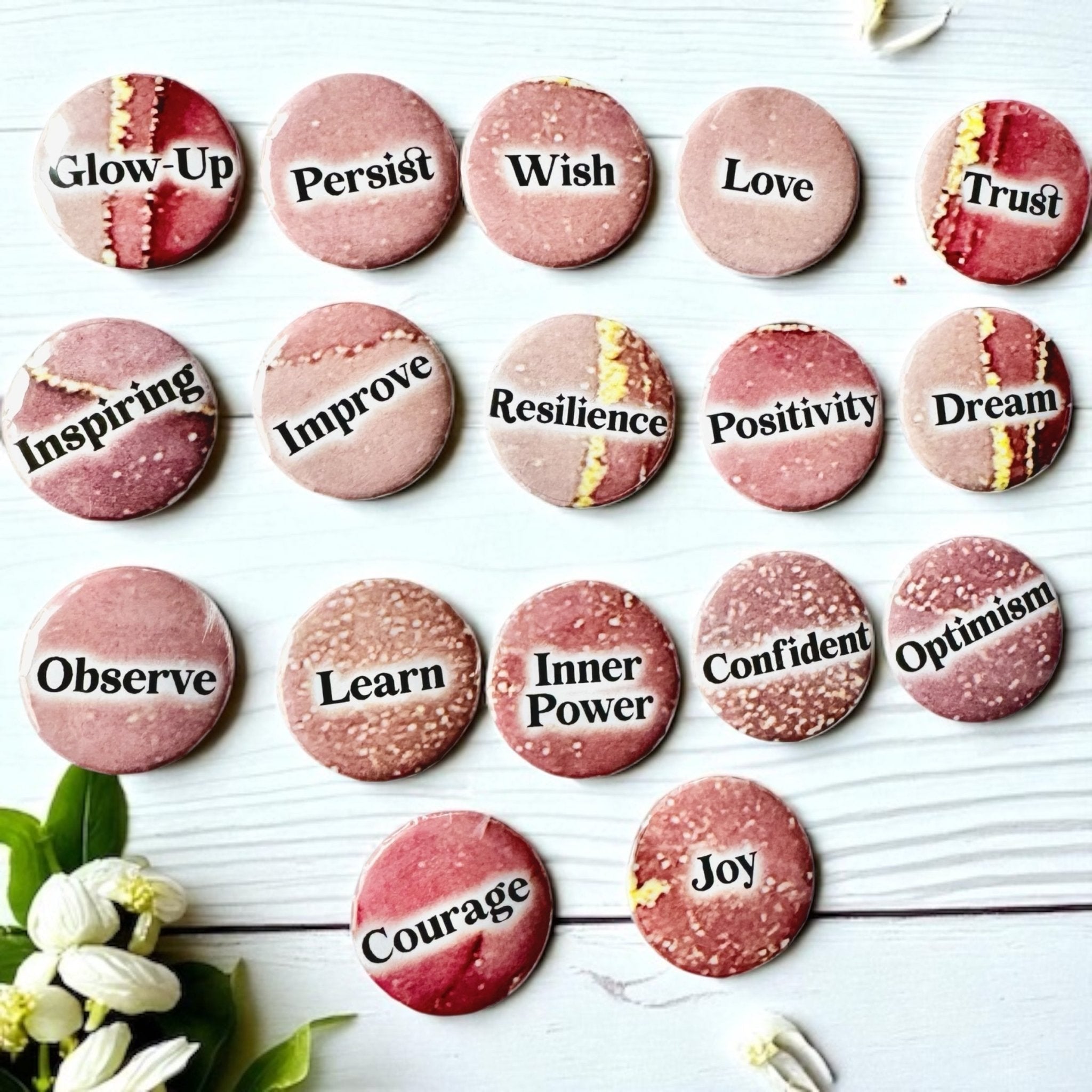 Set of 1-inch affirmation buttons with positive affirmations on a soft, pale pink background, protected by a clear plastic coating, ideal for charm casting, journaling, oracle card spreads, and daily inspiration.  