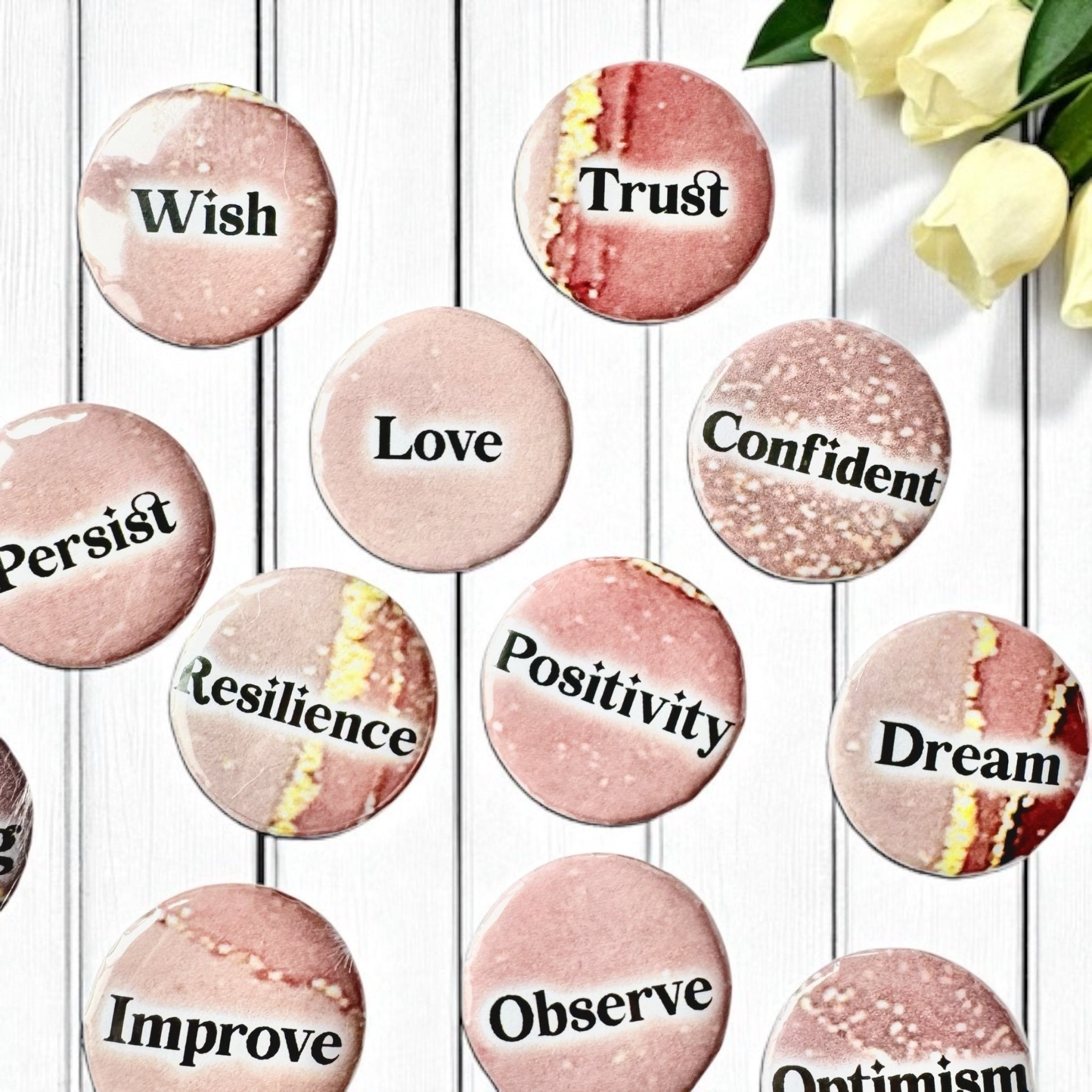 Set of 1-inch affirmation buttons with positive affirmations on a soft, pale pink background, protected by a clear plastic coating, ideal for charm casting, journaling, oracle card spreads, and daily inspiration.  