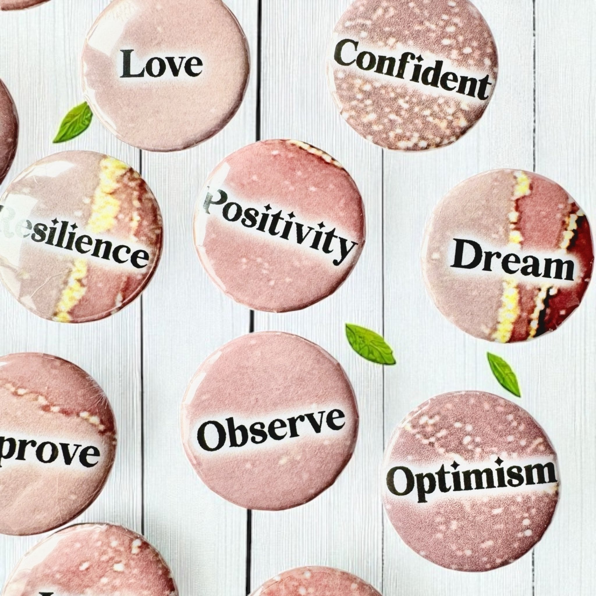 Set of 1-inch affirmation buttons with positive affirmations on a soft, pale pink background, protected by a clear plastic coating, ideal for charm casting, journaling, oracle card spreads, and daily inspiration.  