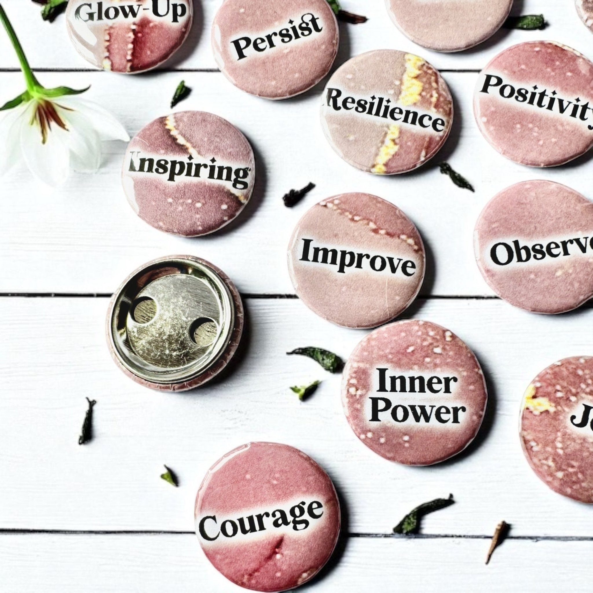 Set of 1-inch affirmation buttons with positive affirmations on a soft, pale pink background, protected by a clear plastic coating, ideal for charm casting, journaling, oracle card spreads, and daily inspiration.  