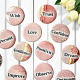 Set of 1-inch affirmation buttons with positive affirmations on a soft, pale pink background, protected by a clear plastic coating, ideal for charm casting, journaling, oracle card spreads, and daily inspiration.  