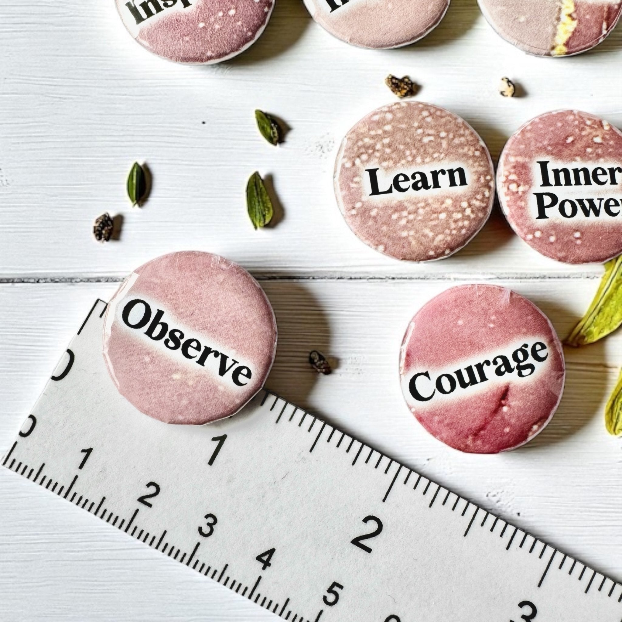 Set of 1-inch affirmation buttons with positive affirmations on a soft, pale pink background, protected by a clear plastic coating, ideal for charm casting, journaling, oracle card spreads, and daily inspiration.  