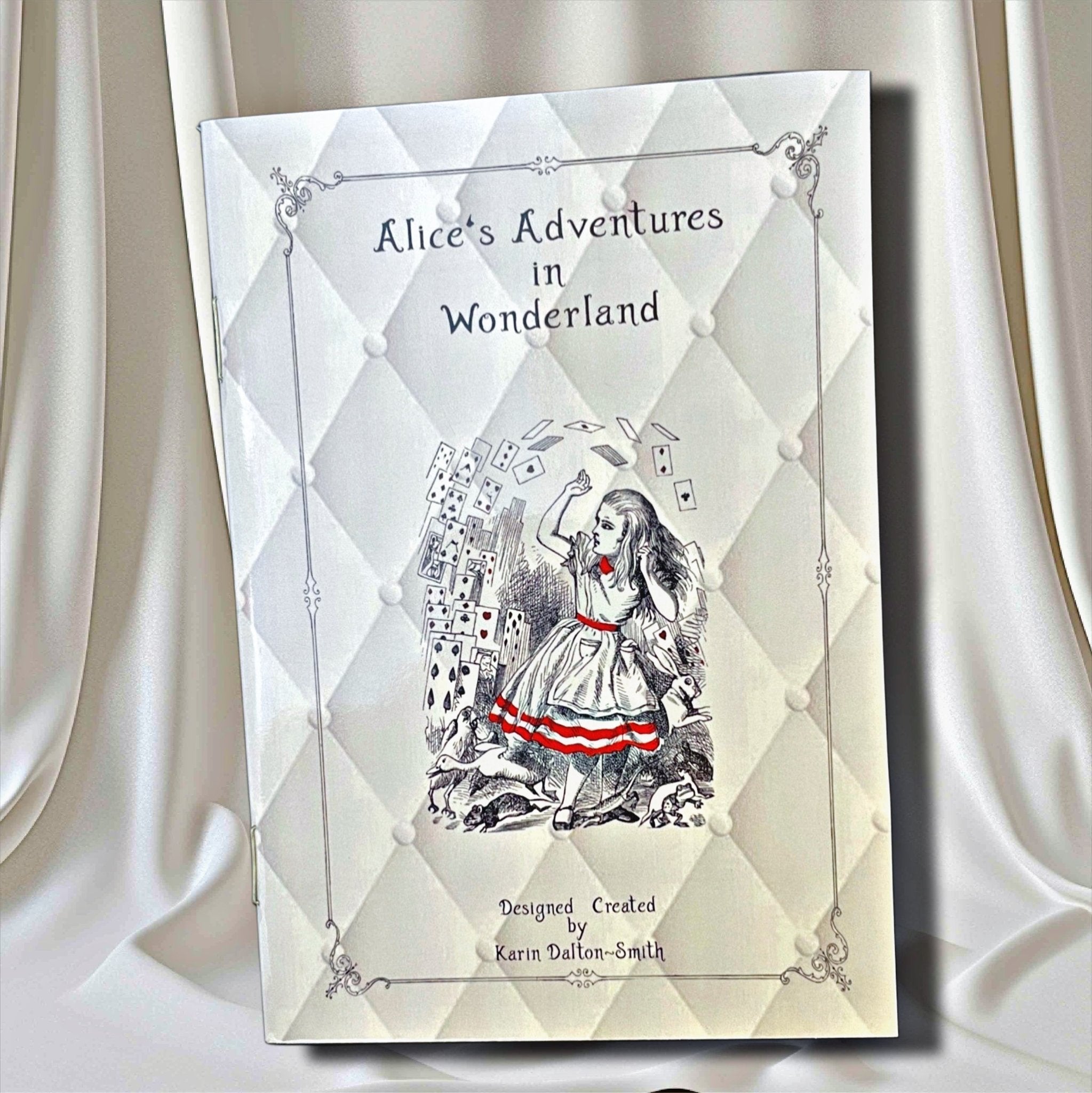 Book cover of 'Alice's Adventures in Wonderland' with a diamond pattern and illustration of Alice on a white curtain background.