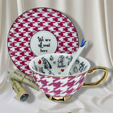 Teacup and saucer set with pink and white houndstooth pattern, featuring a quote and Alice in Wonderland design.