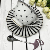 Side profile view Alice in Wonderland Spots and stripes fortune telling tea cup set.