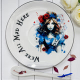 Overhead shot of the Saucer, featuring the Alice Queen of Hearts portrait, 'We're All Mad Here' text, and flamingo spoon
