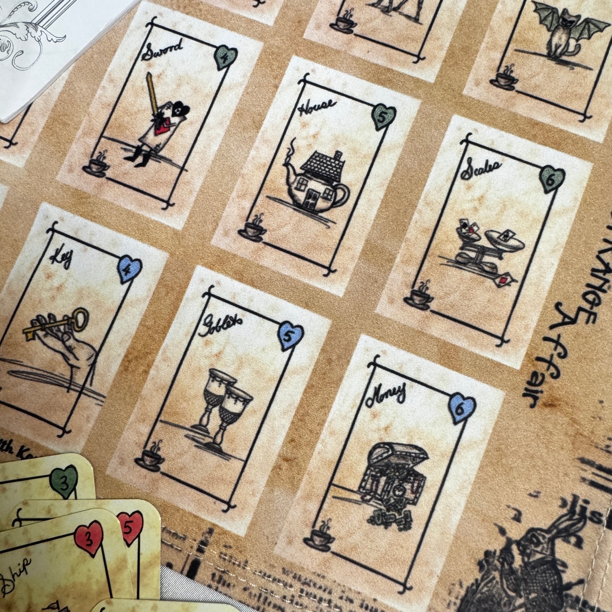 This is a unique divination system all in one tinned kit.  It is based upon tea leaf reading and Alice in Wonderland theme. It has a washable spandex mat and 18 mini cards and 18 charms and 3 dice.