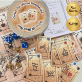 Curated Tea Alice in Wonderland kit with cards, dice, and tins on a patterned background
